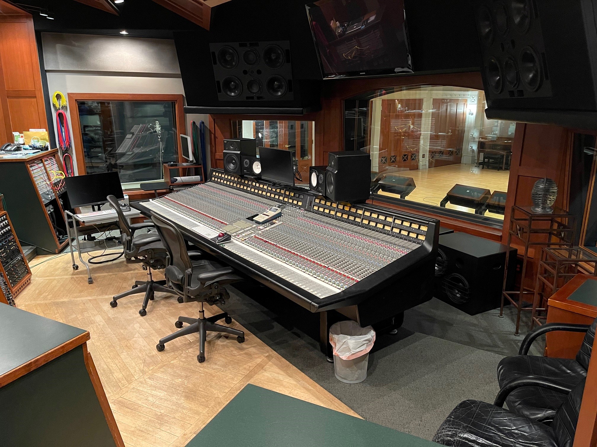 Recording studio control room with large-format mixing console, near-field monitors, and outboard equipment racks